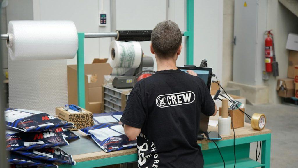 a-man-standing-in-front-of-a-machine-in-a-factory-d4plciba1ew
